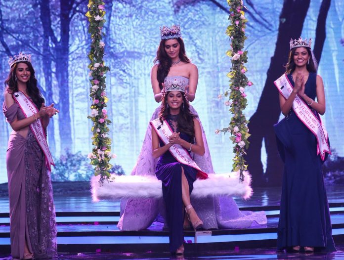 Anukreethy Vas (center) is crowned by Manushi Chhillar